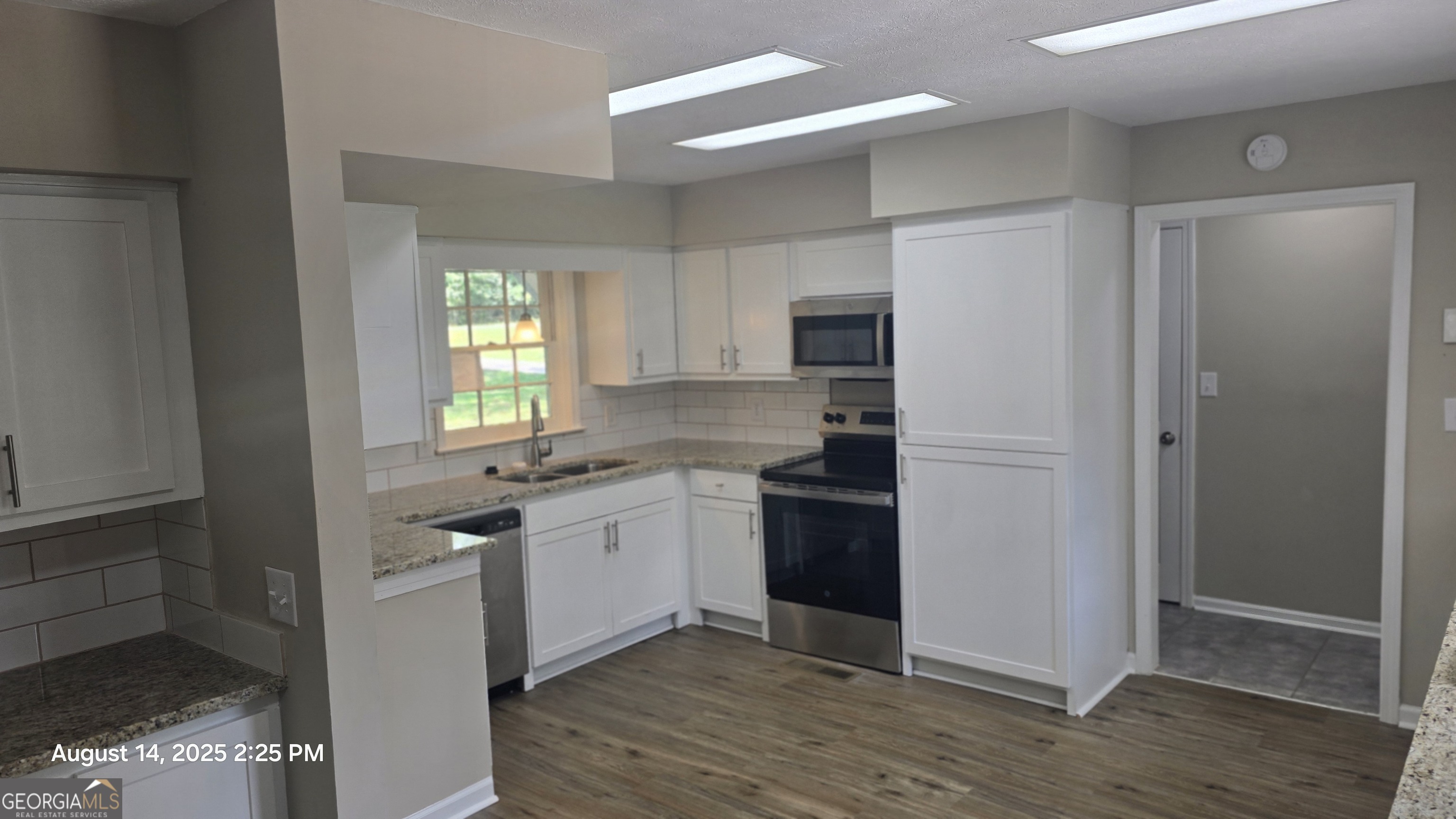 601 Youngs Mill Road Americus, GA 31719 - Photo 9 of 39 a kitchen with stainless steel appliances granite countertop a sink and a refrigerator