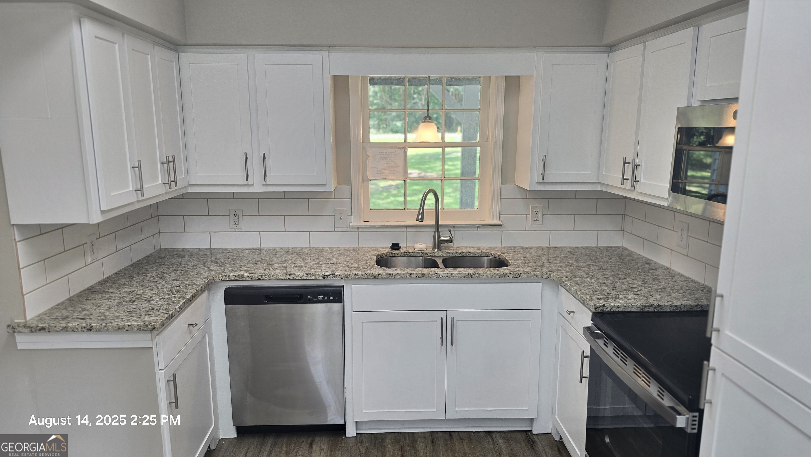 601 Youngs Mill Road Americus, GA 31719 - Photo 10 of 39 a kitchen with stainless steel appliances granite countertop a sink stove and cabinets