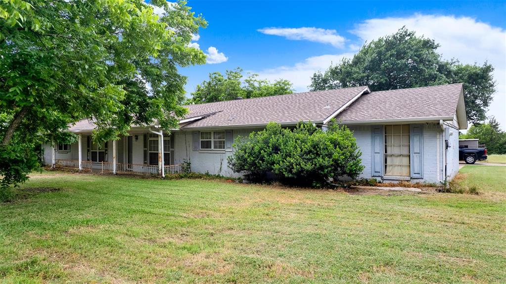 1415 South Joe Wilson Road Cedar Hill, TX 75104 - Photo 2 of 17 a front view of a house with a garden