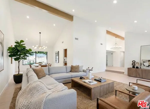 a large kitchen with stainless steel appliances granite countertop a sink and cabinets with wooden floor