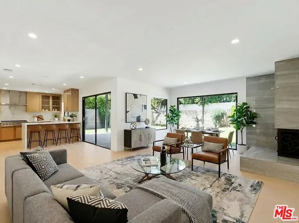 a spacious bedroom with a bed and a flat screen tv