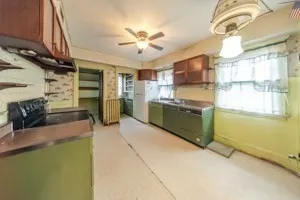 a kitchen with stainless steel appliances granite countertop a sink and a refrigerator