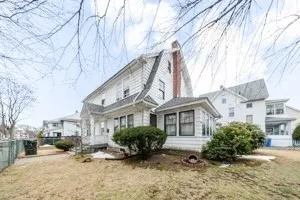 a view of a house with a yard covered in snow