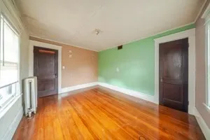 wooden floor in an empty room with a window
