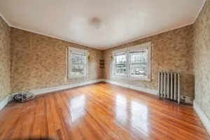 wooden floor in an empty room with a window