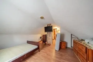 a view of game room with window and wooden floor