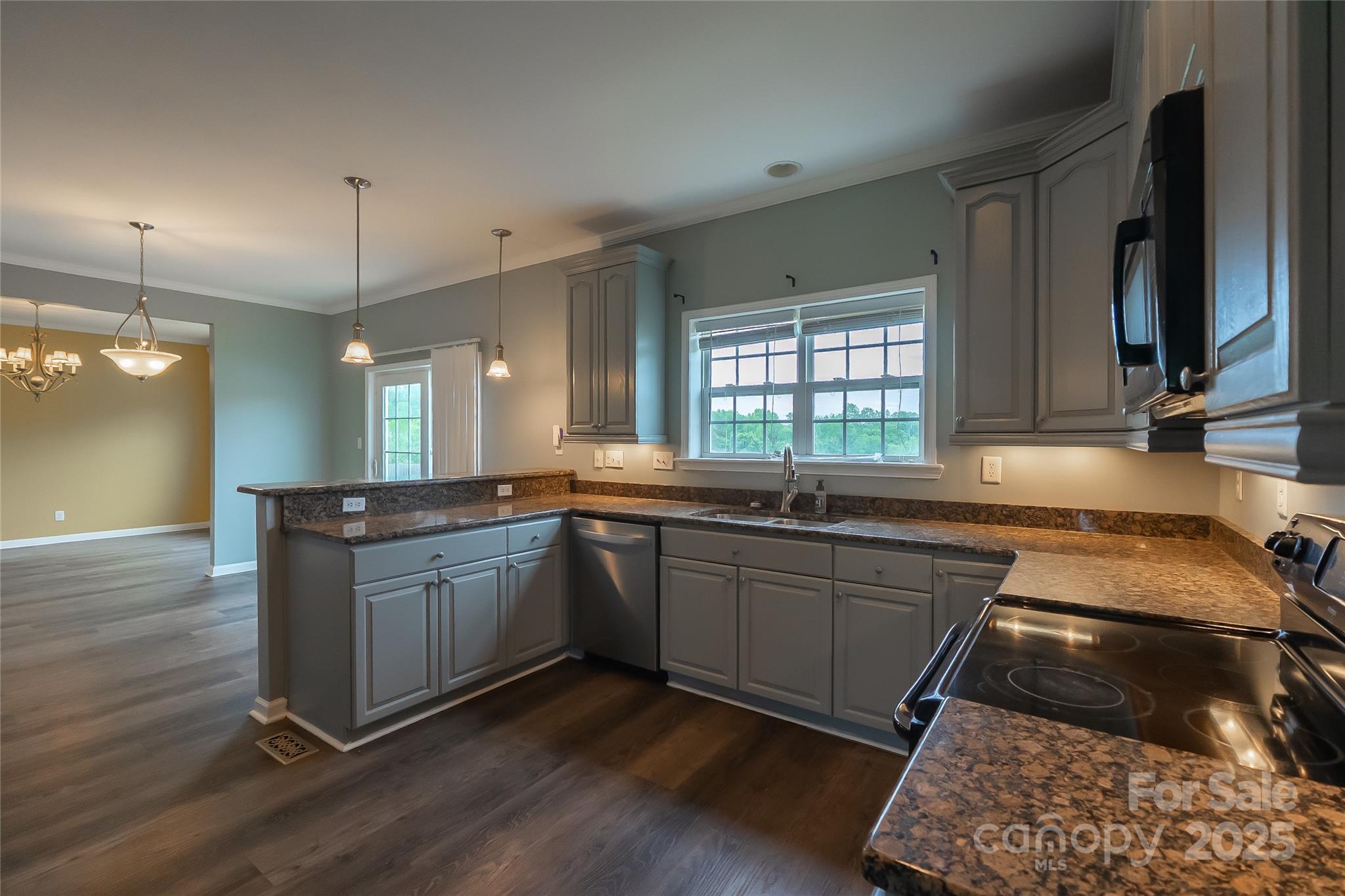 7740 Freeze Road Kannapolis, NC 28081 - Photo 14 of 43 a kitchen with stainless steel appliances granite countertop a stove a sink and a wooden floors