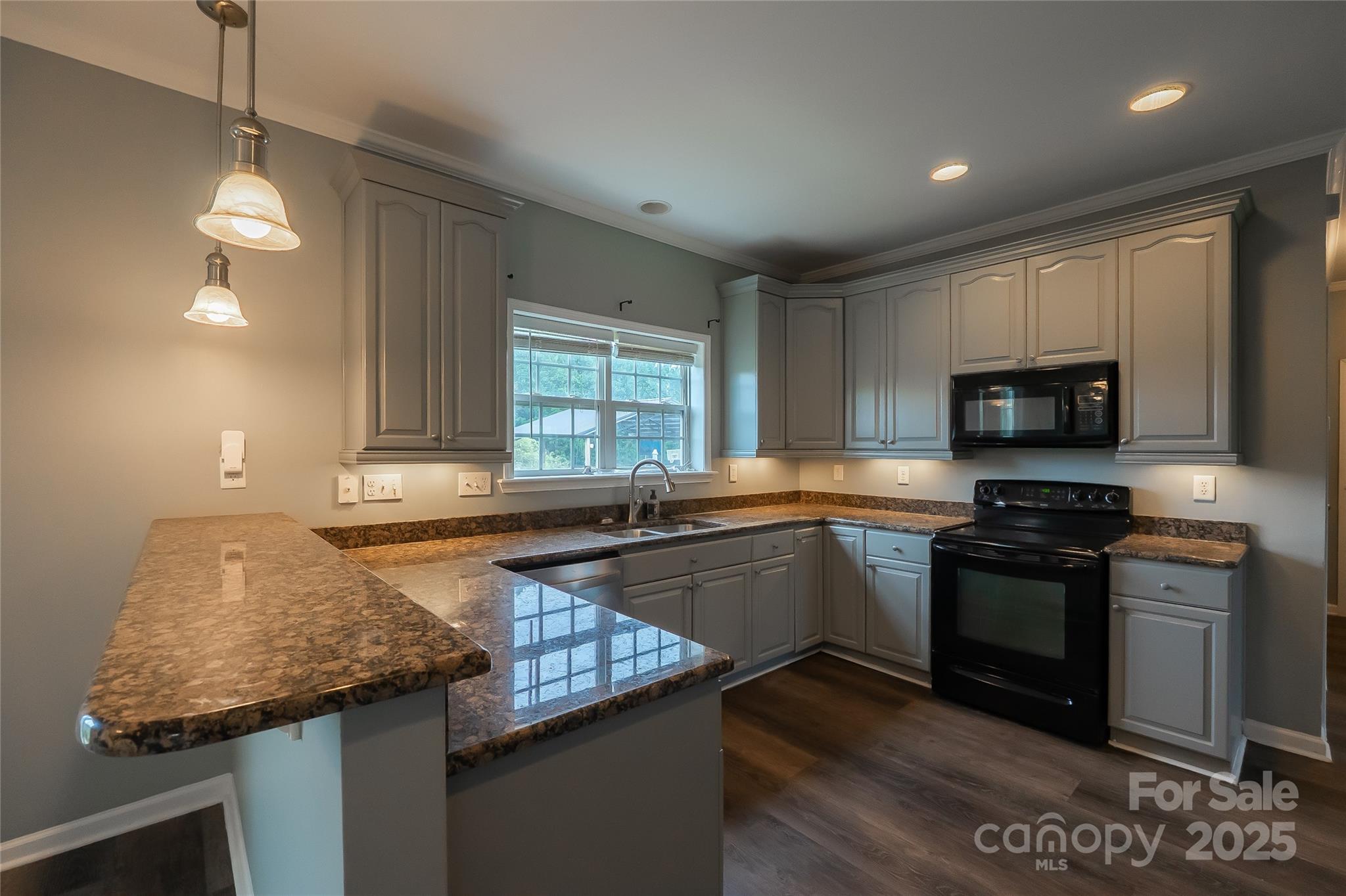 7740 Freeze Road Kannapolis, NC 28081 - Photo 16 of 43 a kitchen with granite countertop stainless steel appliances a sink stove top oven and cabinets