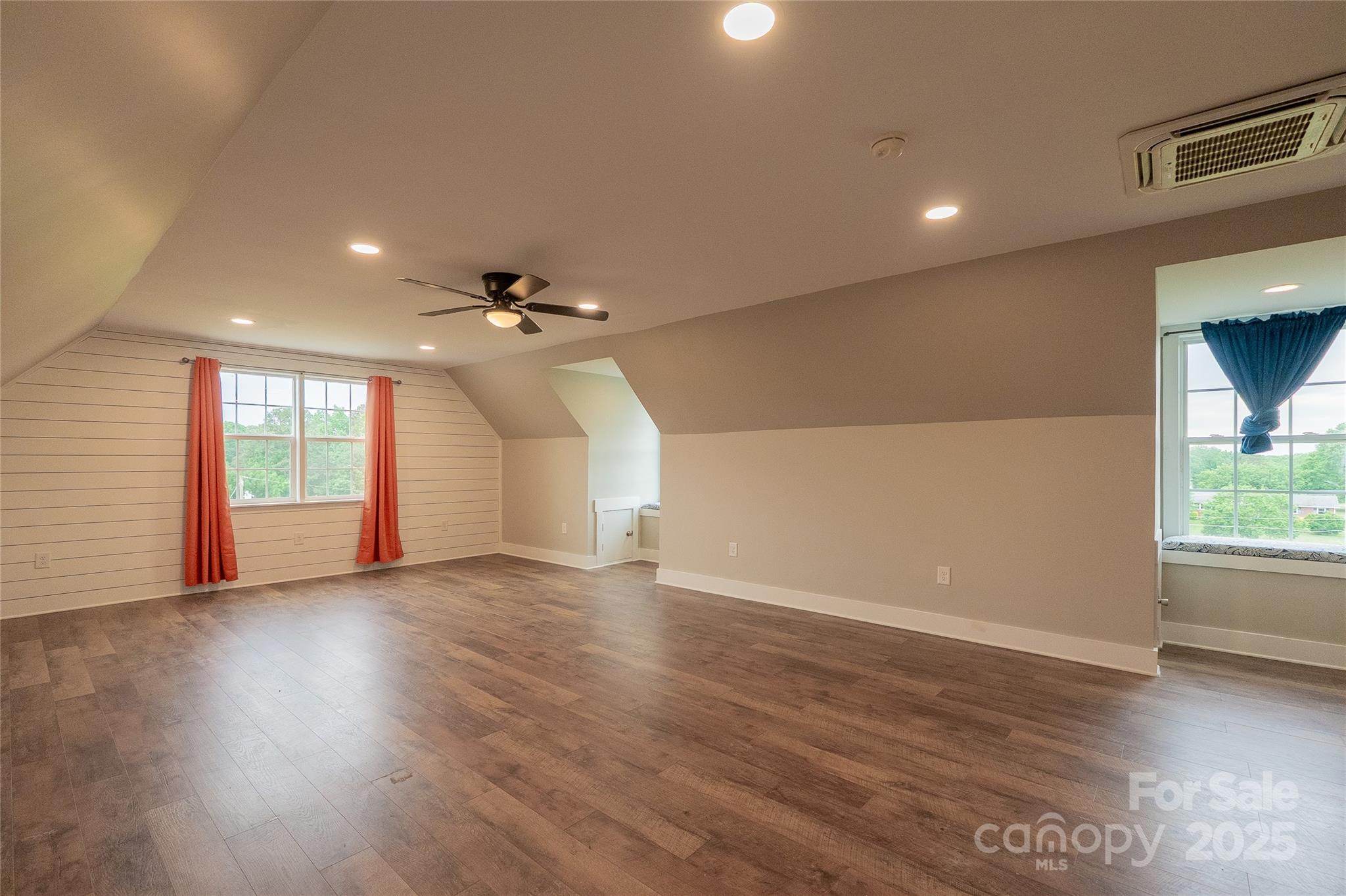 7740 Freeze Road Kannapolis, NC 28081 - Photo 3 of 43 an empty room with wooden floor chandelier fan and windows
