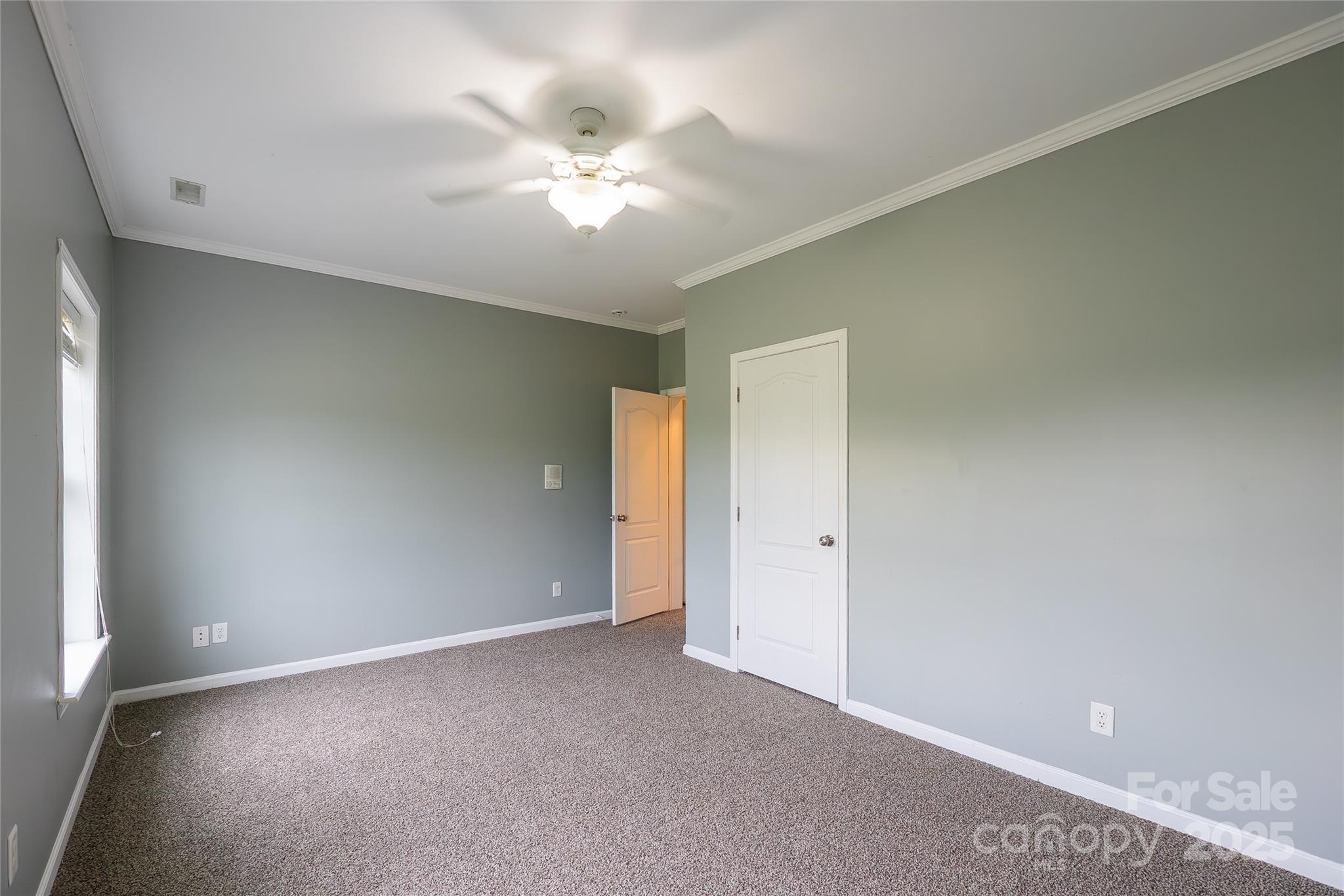 7740 Freeze Road Kannapolis, NC 28081 - Photo 36 of 43 an empty room with a chandelier fan