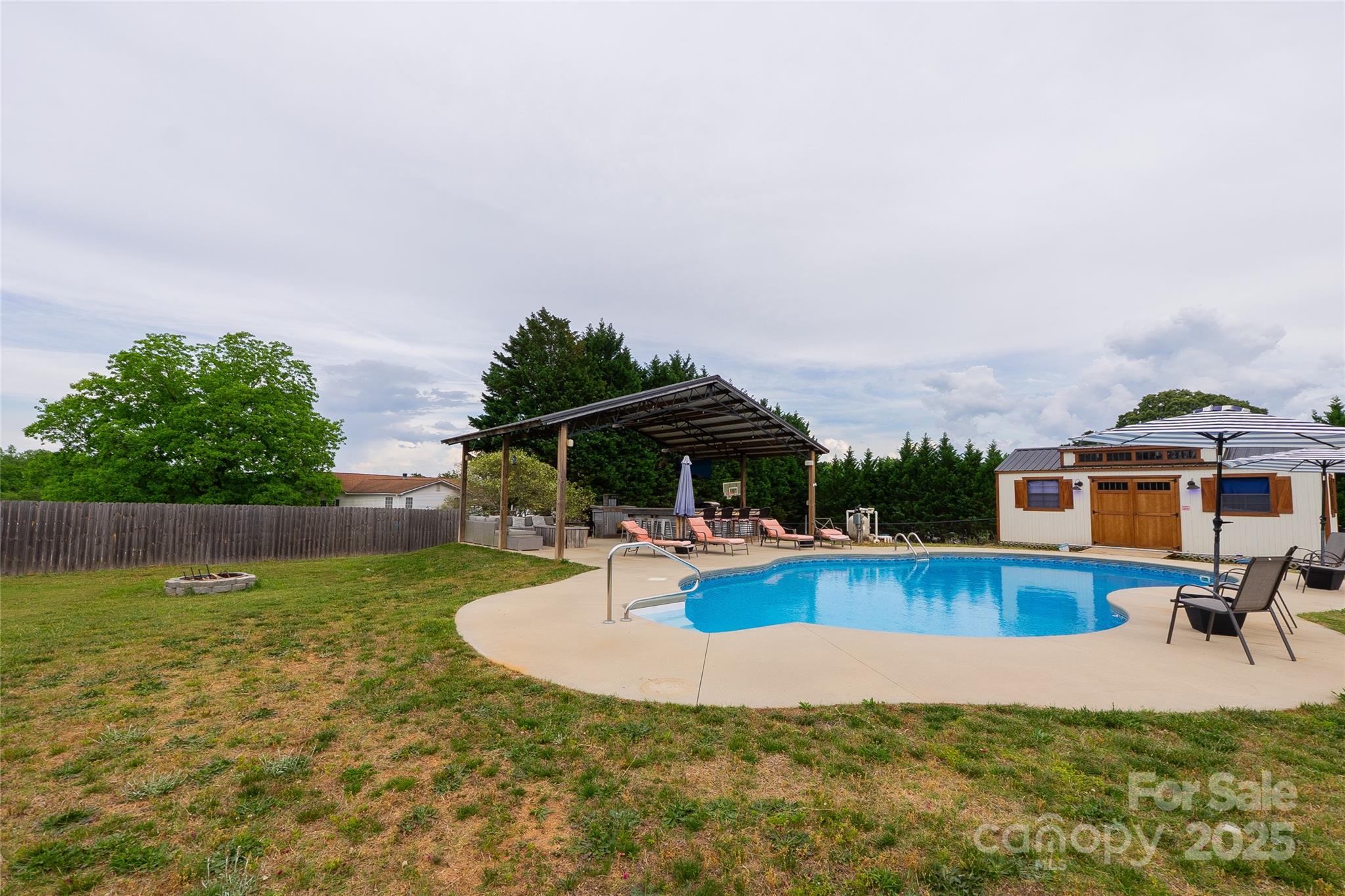 7740 Freeze Road Kannapolis, NC 28081 - Photo 9 of 43 a view of a swimming pool with a lounge chairs