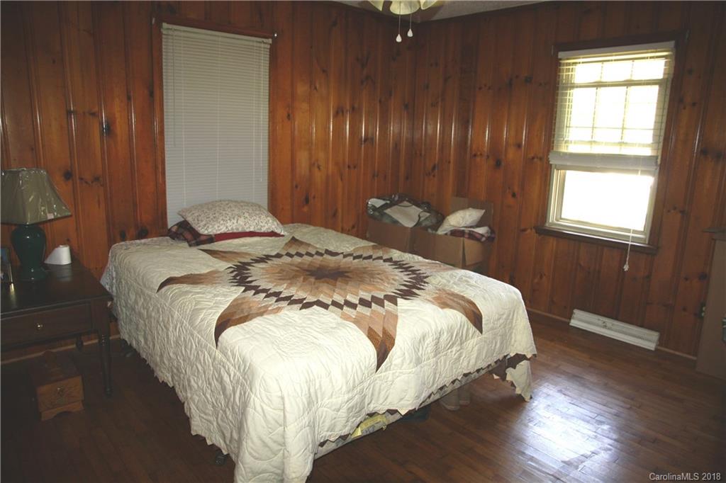 878 Sherwood Road Clover, SC 29710 - Photo 12 of 21 a bed sitting in a spacious bedroom next to a window and chandelier