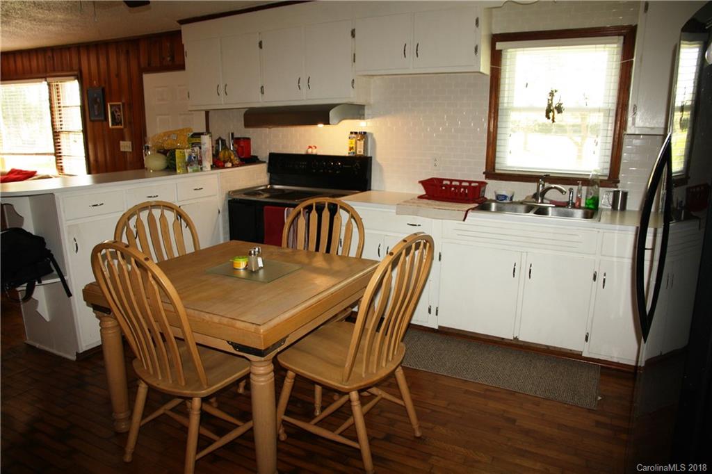 878 Sherwood Road Clover, SC 29710 - Photo 6 of 21 a kitchen with a dining table chairs and white appliances
