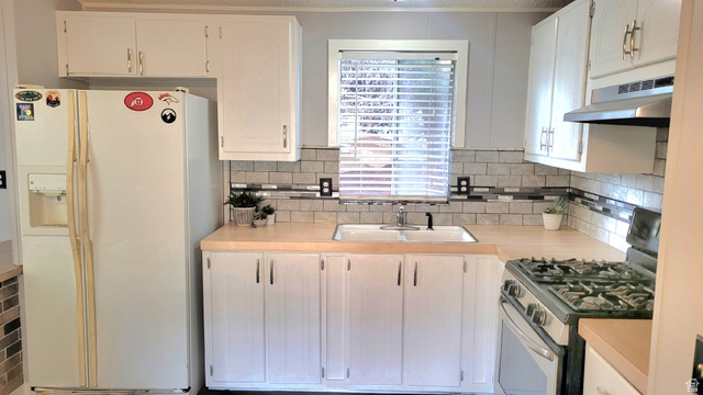 1525 South 400 East, Unit 63 Springville, UT 84663 - Photo 9 of 36 Kitchen with stainless steel gas range oven, white refrigerator with ice dispenser, light countertops, and white cabinets