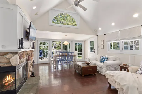 a living room with furniture and a floor to ceiling window