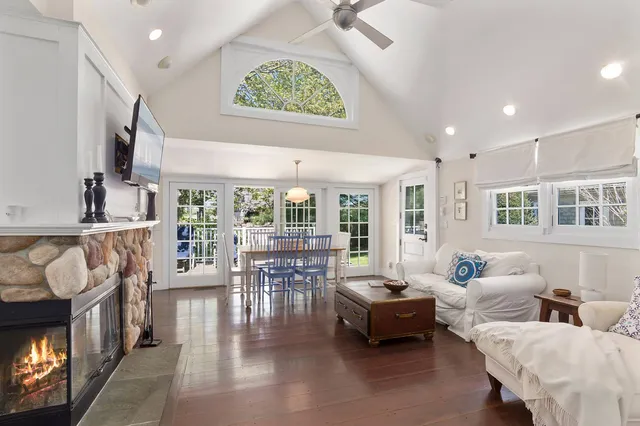 a living room with furniture and a floor to ceiling window