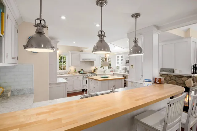 a kitchen with stainless steel appliances a sink stove and refrigerator