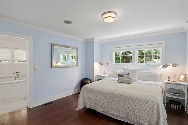 a bedroom with a large bed and a chandelier