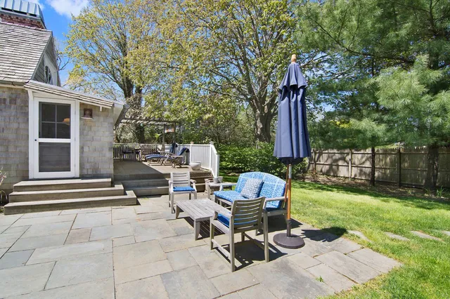a view of backyard with seating space and trees