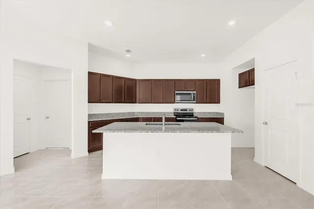 a kitchen with stainless steel appliances granite countertop a stove and a refrigerator