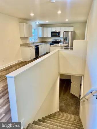 a kitchen with stainless steel appliances a refrigerator sink and microwave