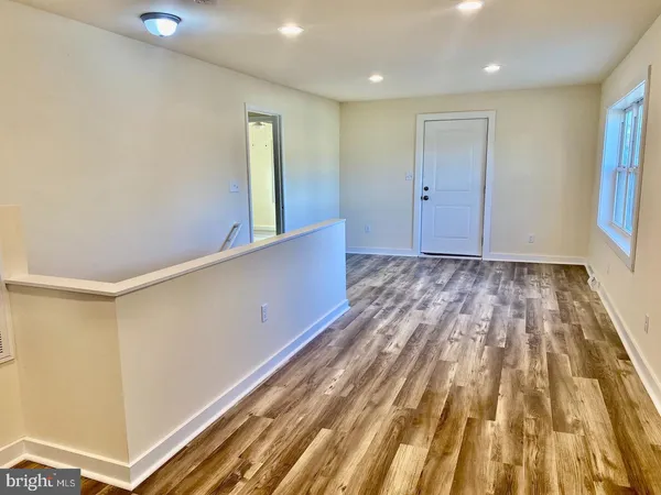 a view of hallway with wooden floor