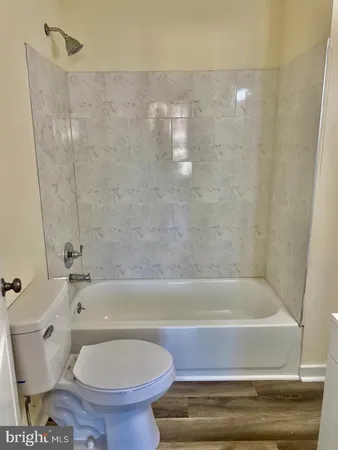 a bathroom with a toilet and a bathtub