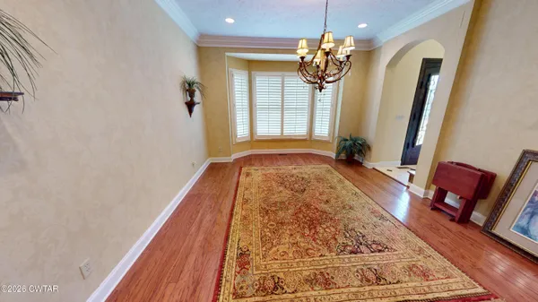 a view of a livingroom with a dinning area fireplace and a window