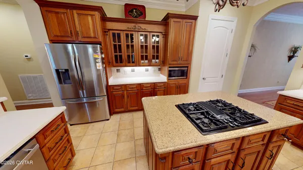 a kitchen with stainless steel appliances granite countertop a sink and a stove