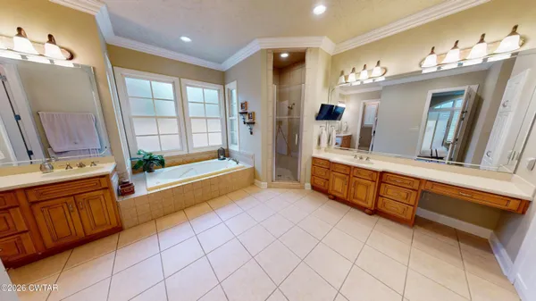 a bathroom with a sink a toilet a tub and shower