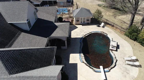 a view of a house with backyard and sitting area