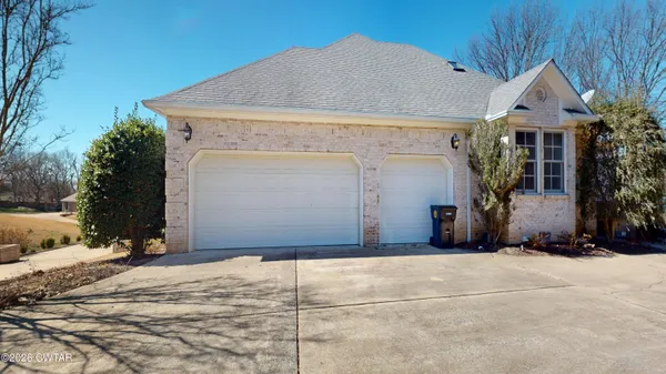 a living room with fireplace furniture and a floor to ceiling window