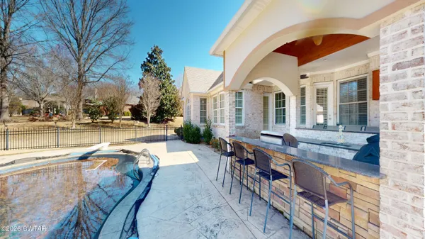 a view of a swimming pool with a yard