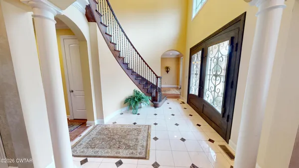 a view of living room with furniture and mirror