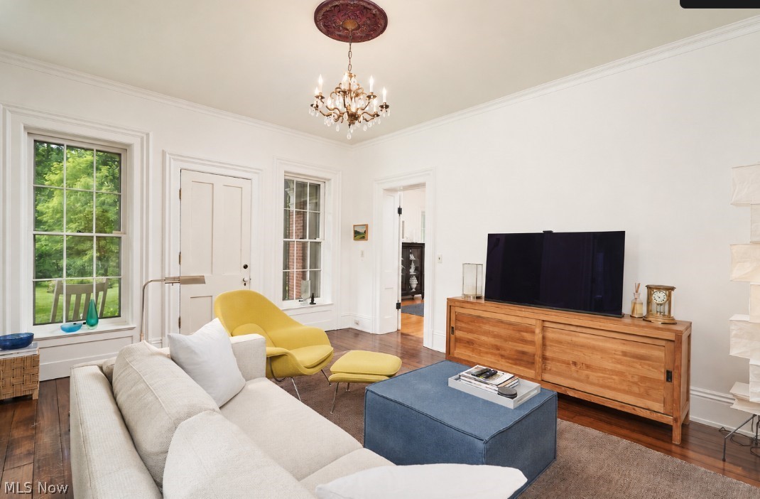 5046 Alger Road Richfield, OH 44286 - Photo 12 of 49 Living area featuring wood-finish flooring, white painted walls, and a decorative ceiling medallion with a chandelier