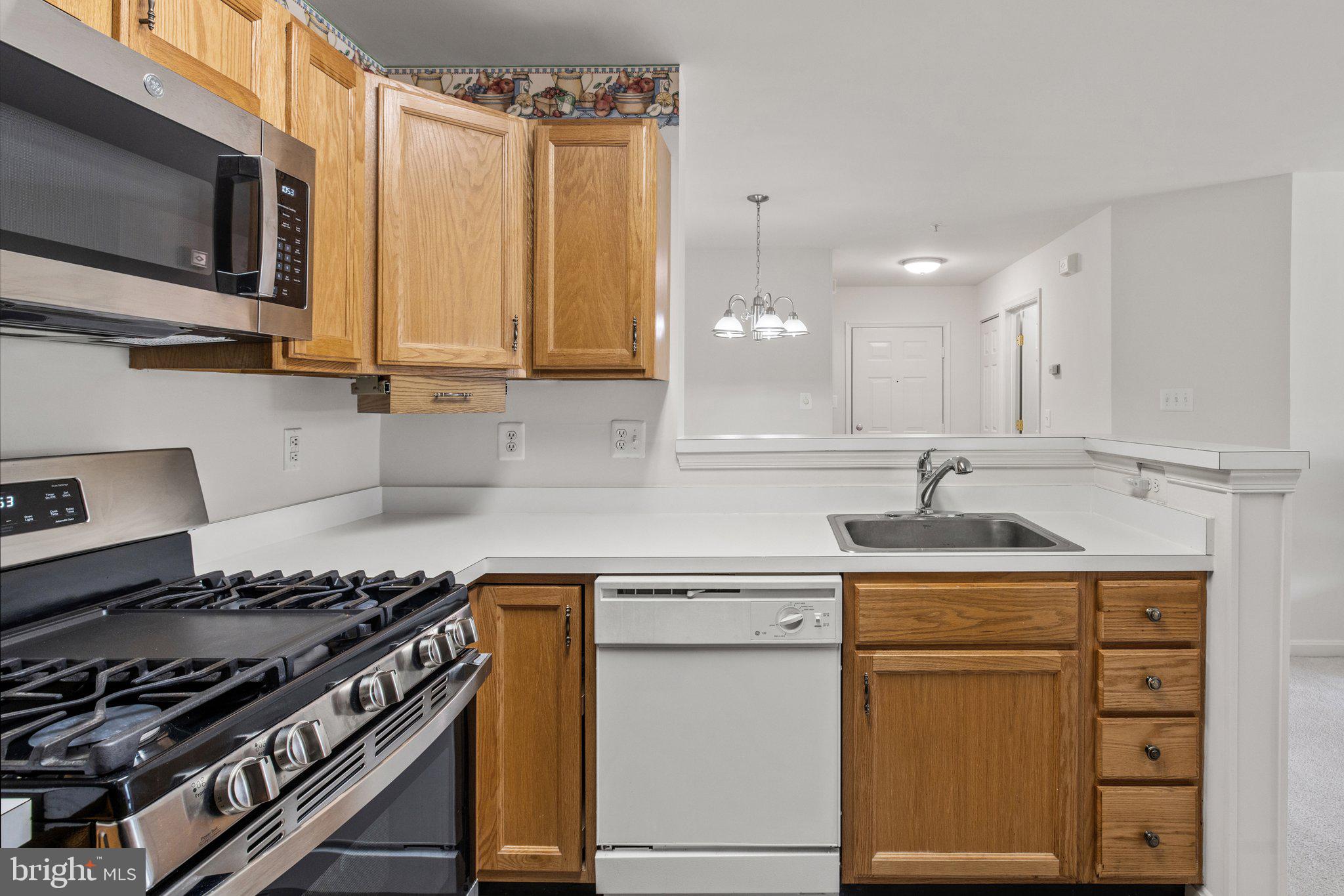 1049 Gardenview Loop, Unit 203 Woodbridge, VA 22191 - Photo 12 of 25 a kitchen with a stove and a sink