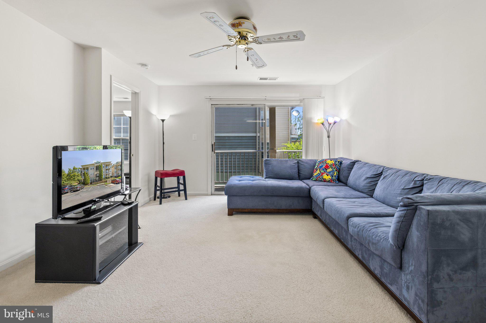 1049 Gardenview Loop, Unit 203 Woodbridge, VA 22191 - Photo 13 of 25 a living room with furniture and a flat screen tv