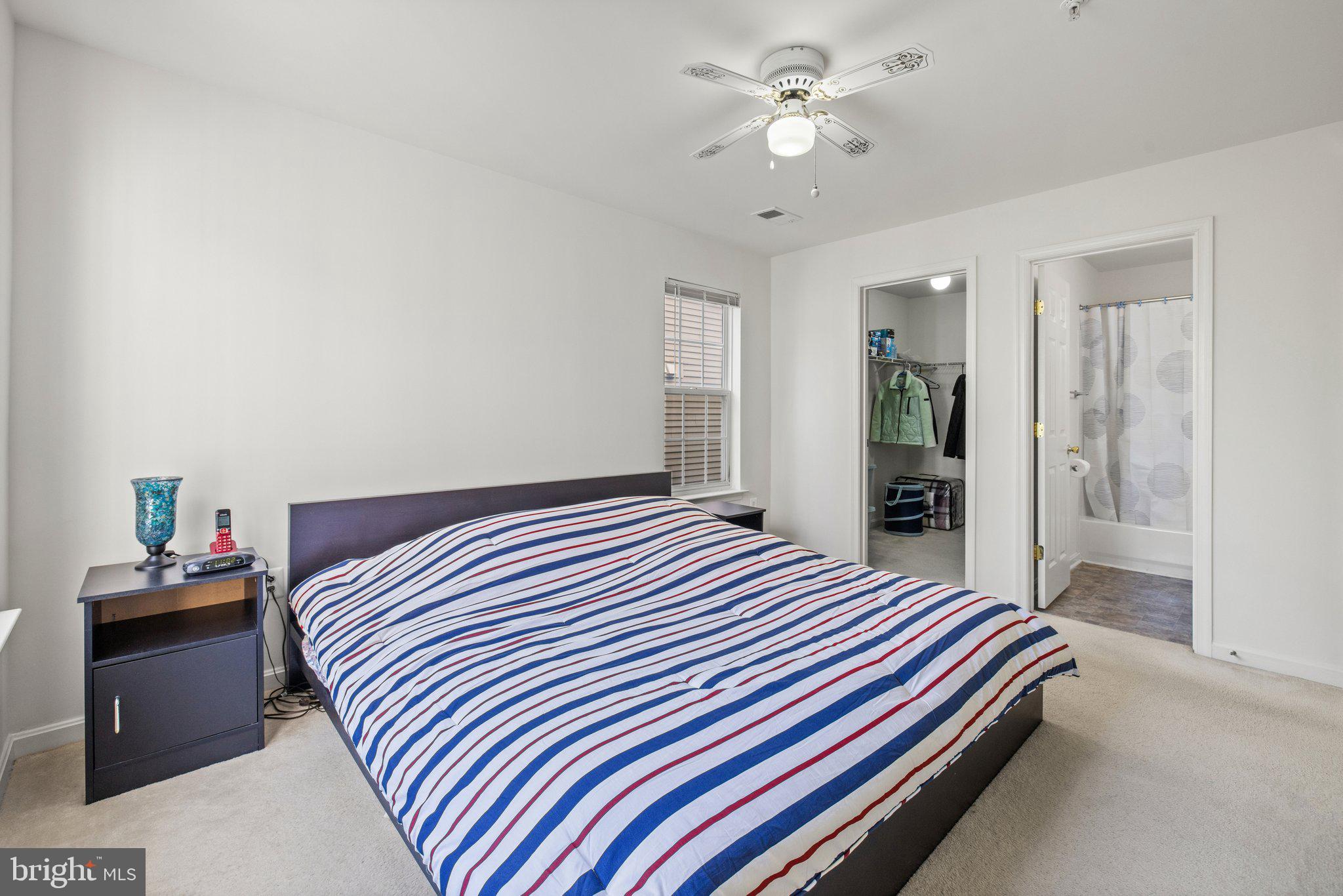 1049 Gardenview Loop, Unit 203 Woodbridge, VA 22191 - Photo 17 of 25 a bedroom with bed and a chandelier