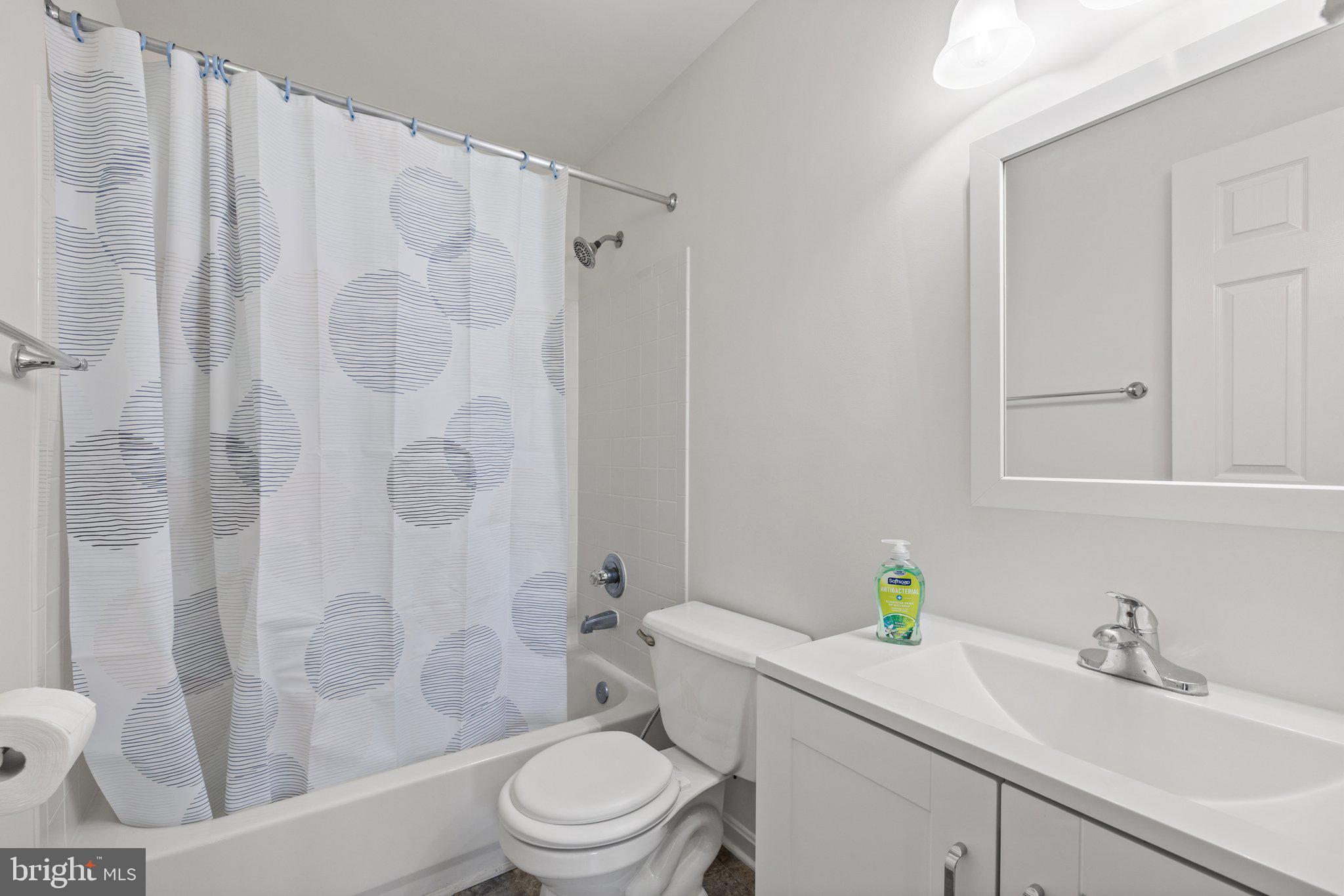 1049 Gardenview Loop, Unit 203 Woodbridge, VA 22191 - Photo 18 of 25 a bathroom with a sink toilet and shower