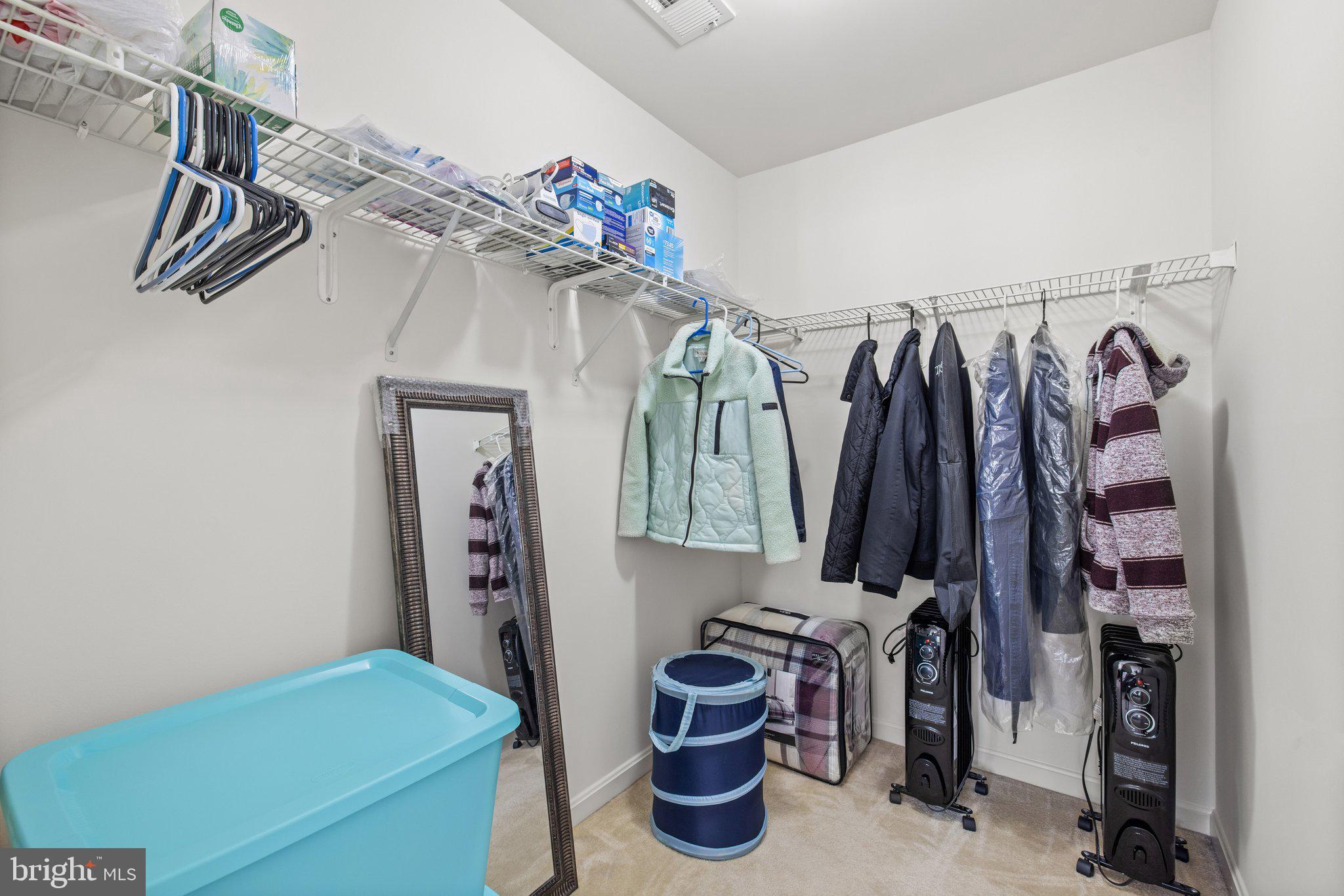 1049 Gardenview Loop, Unit 203 Woodbridge, VA 22191 - Photo 19 of 25 a view of walk in closet with clothes