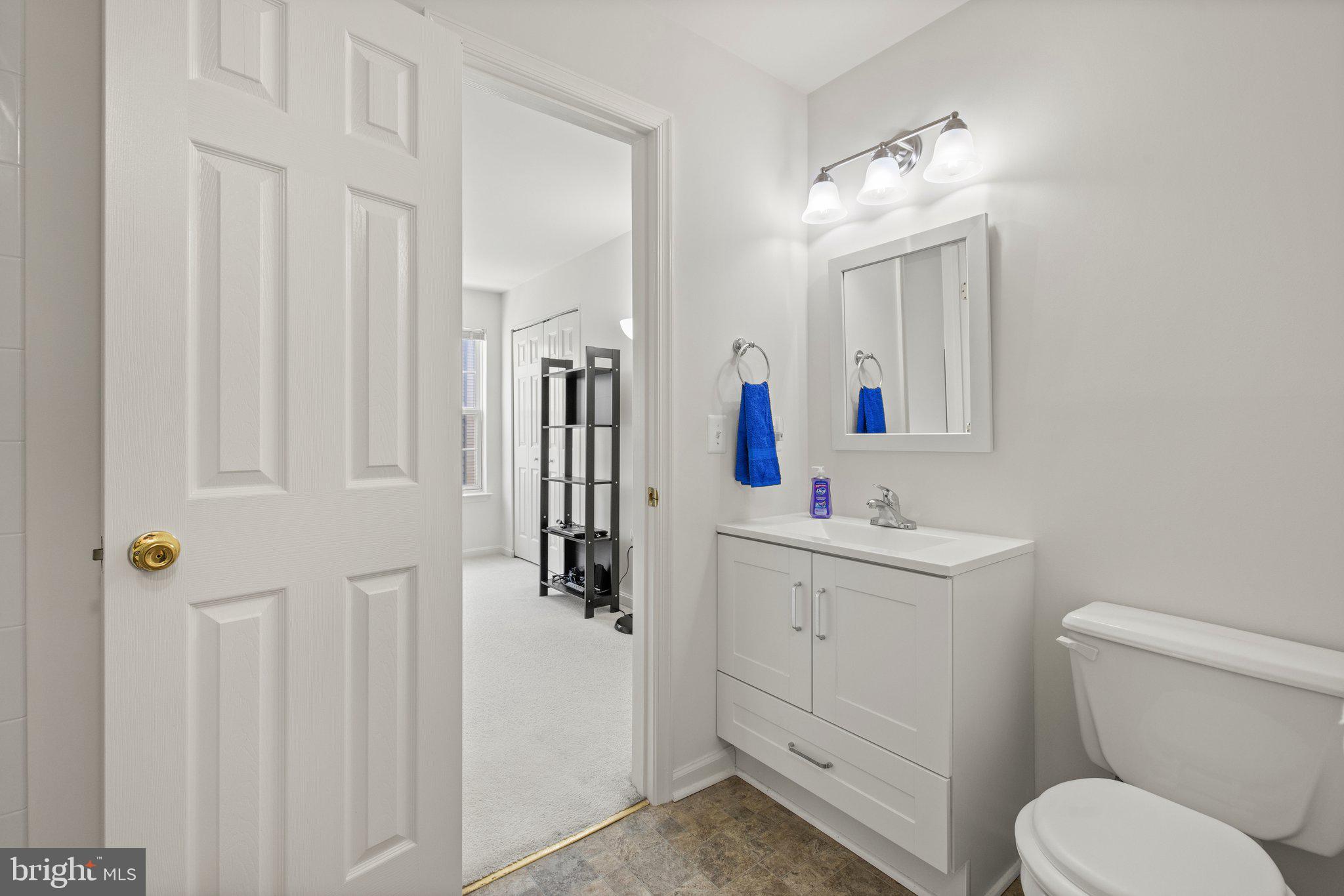 1049 Gardenview Loop, Unit 203 Woodbridge, VA 22191 - Photo 21 of 25 a bathroom with a toilet sink and mirror
