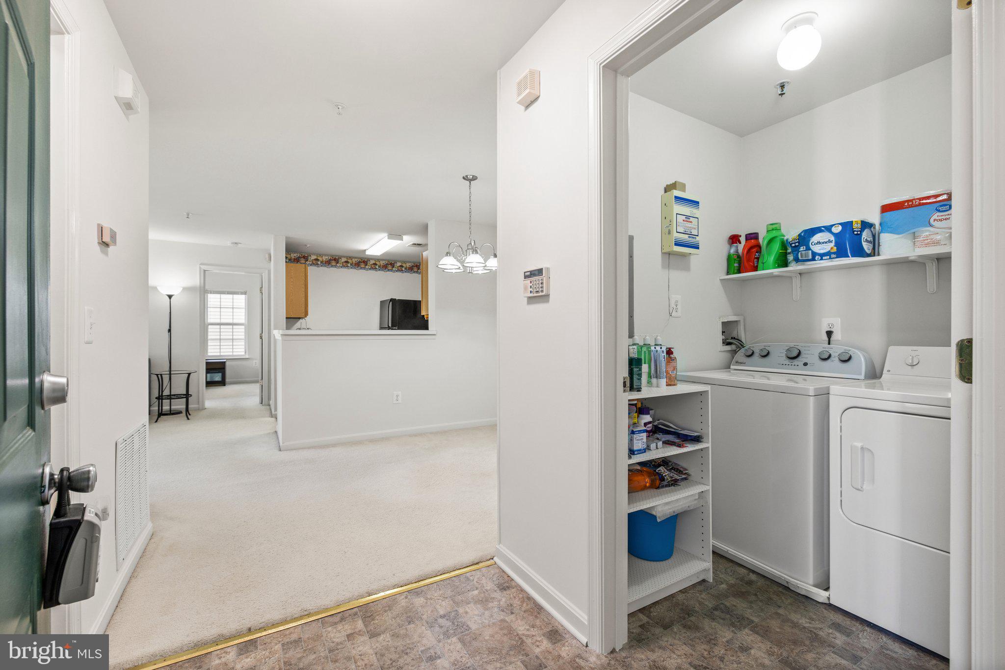 1049 Gardenview Loop, Unit 203 Woodbridge, VA 22191 - Photo 4 of 25 a view of kitchen with refrigerator and white cabinets