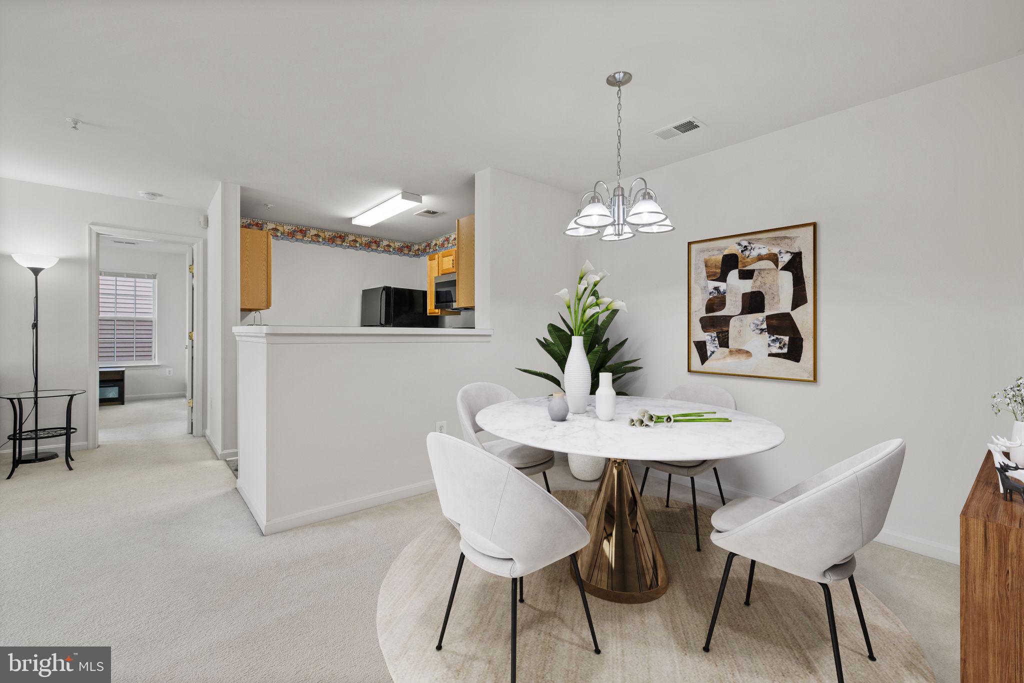 1049 Gardenview Loop, Unit 203 Woodbridge, VA 22191 - Photo 6 of 25 a dining room with furniture and window