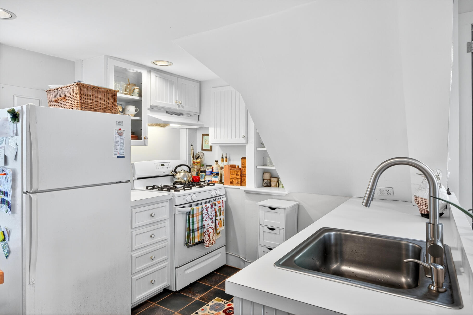 4 Highland Road, Unit C Truro, MA 02666 - Photo 7 of 21 a kitchen with refrigerator a stove a microwave and cabinets