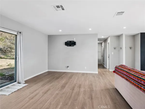 a view of kitchen with furniture and wooden floor