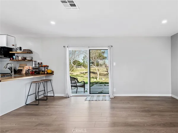a view of kitchen with stainless steel appliances granite countertop a refrigerator and a stove top oven