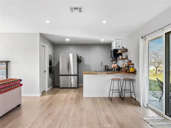 a kitchen with stainless steel appliances granite countertop a refrigerator a stove and a sink
