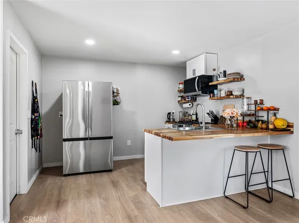 a kitchen with stainless steel appliances granite countertop a refrigerator stove top oven and sink