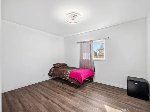 a view of room with window and wooden floor