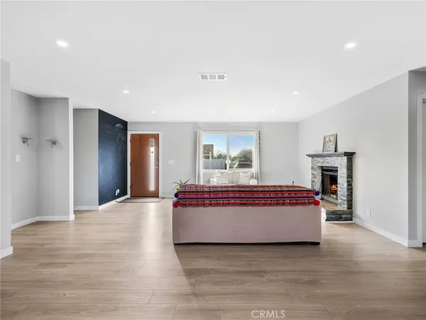 a living room with furniture and kitchen view